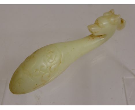 A Chinese White Jade Scroll Weight, carved in the form of a mythological creature, approx 14.5 cms.