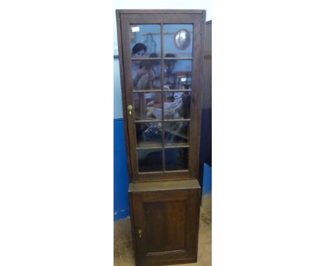 An Oak Glazed Front Display Cabinet, with three internal shelves and a cupboard beneath, approx 49 x 28 x 177 cms.