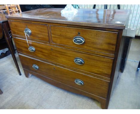 An Antique Mahogany Chest of Drawers, with two short and two long drawers, on bracket feet with oval brass embossed handles, 