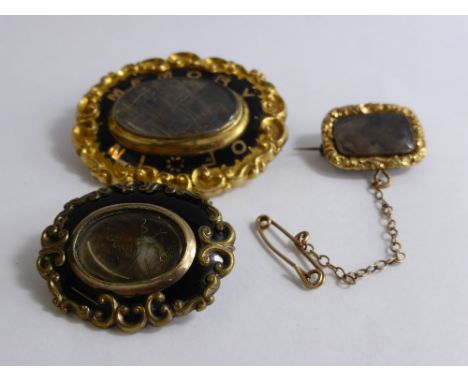 Three Antique Mourning Brooches, one 9 ct gold and enamel having floral border and inlaid "In Memory Of" together with two ot