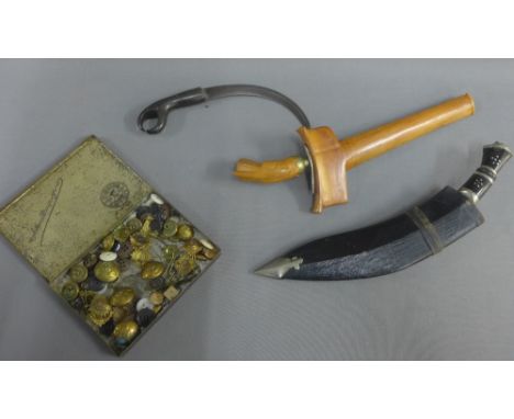 Kukri dagger, a Kris, a small curved dagger and a tin containing various military buttons etc., (a lot) 