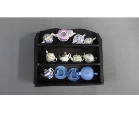Collection of miniature teapots to include Royal Doulton and Wedgwood etc., together with a display shelf, (13) 