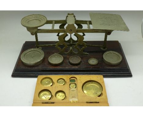 A set of postal scales marked S. Mordan & Co. with weights and a boxed set of weights