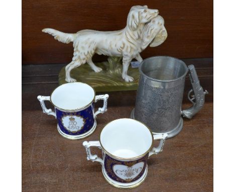 A Crown Devon Fieldings hunting dog figure, two Royal Crown Derby commemorative loving cups and a tankard