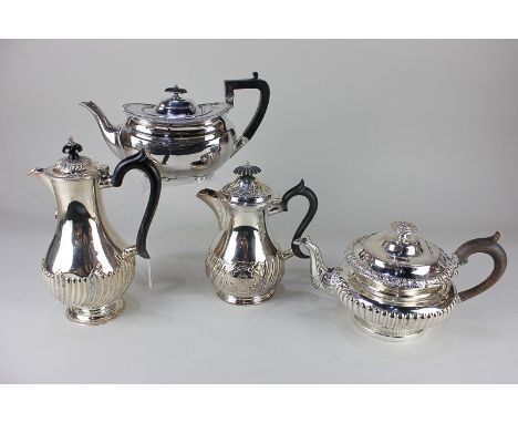 A silver plated circular teapot with demi-fluted decoration, an oval teapot, and two baluster shaped jugs