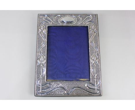 An Edward VII silver photograph frame with embossed Art Nouveau design, maker J &amp; R Griffin, Chester, 1905, 20.5cm by 15.