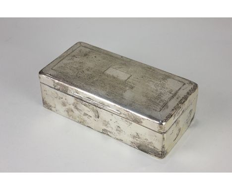A George V silver rectangular cigarette box with engine turned engraved lid (a/f - hinges strained), London 1921, 18cm