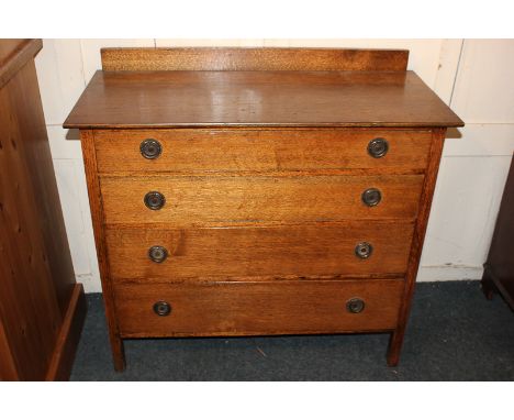 An oak chest of four graduated drawers, with rectangular top, the drawers with circular stamped backplated and drop ring hand
