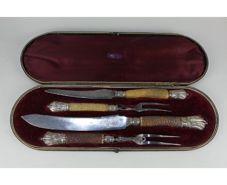 A silver mounted horn handled four-piece carving set, cased (a/f - one fork guard missing)