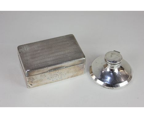 A George V silver capstan inkwell, on loaded circular base, Birmingham 1919, 11cm, and a George V silver rectangular cigarett