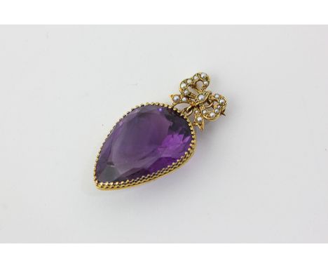 An amethyst brooch, pear shaped on a gilt and split pearl bow