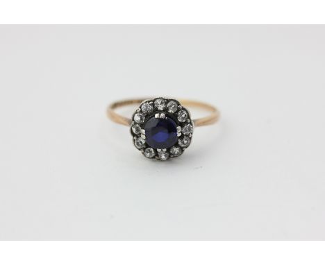 A Swedish sapphire cluster ring the circular stone double claw set within a white sapphire border