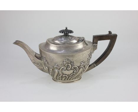 An Edward VII silver oval teapot with embossed scroll and reeded decoration, maker Barker Bros, Chester 1906, gross weight 5.