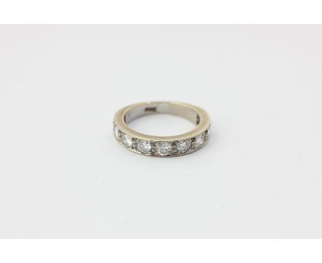 A diamond half hoop ring, set with nine uniform brilliant cut stones