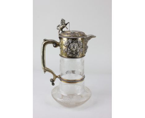 A Victorian silver gilt mounted cut glass claret jug maker John Wilmin Figg, London, 1869, embossed with bacchanalian designs