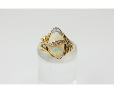 An opal and diamond ring in 18ct yellow gold