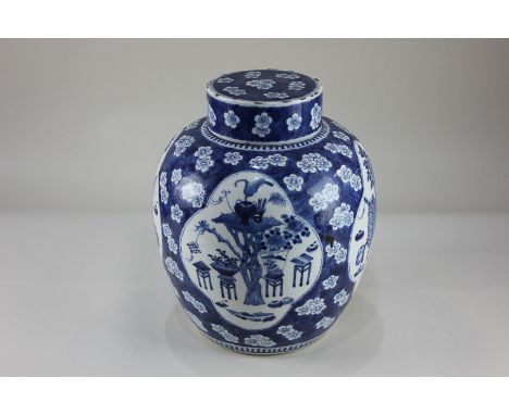 A Chinese blue and white porcelain ginger jar decorated with panels of garden scenes, on blue prunus ground, four-character s