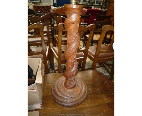 A carved hardwood Table Lamp, the pillar and plinth with an entwined snake, 12'' diameter, 26" tall (shade absent)