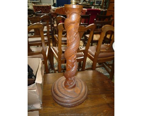 A carved hardwood Table Lamp, the pillar and plinth with an entwined snake, 12'' diameter, 26" tall (shade absent)