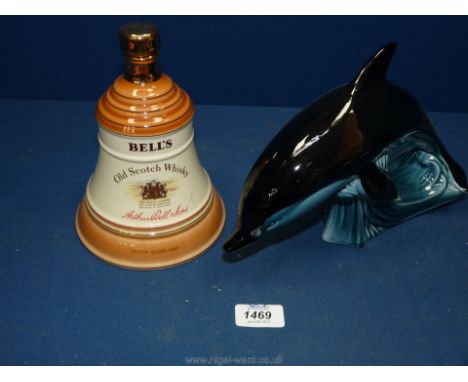 A large Poole Dolphin and a Wade Whiskey bell.