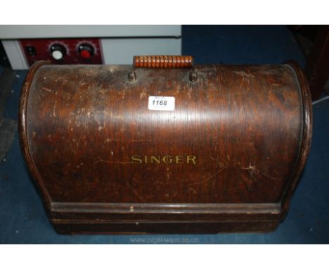 A Singer electric sewing Machine with instructions manual and accessories.