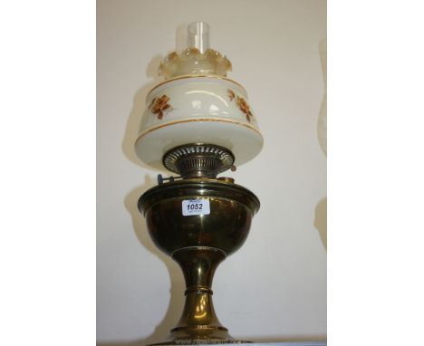 A brass Oil Lamp with cream fluted shade.