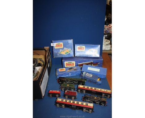 A quantity of Hornby tin plate '00' gauge railway including rolling stock, track and buildings including foot bridge, level c
