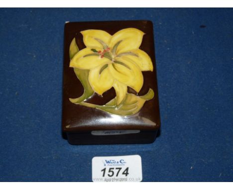 A green Moorcroft trinket Box with yellow flower.