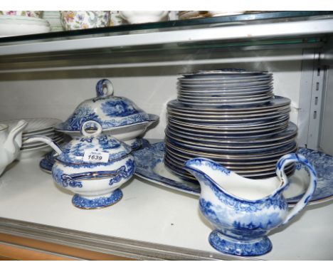 A flow blue Royal Doulton 'Geneva' pattern Dinner service including lidded sauce tureen, ladle and stand, round lidded tureen