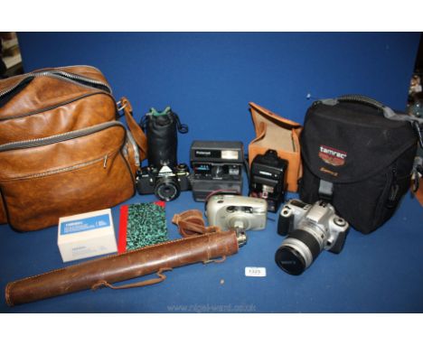 A quantity of camera equipment to include a Canon EOS 300 with Canon 28 90mm lens and a Canon 75-300mm lens, a Pentax ME, a P