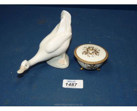 A Nao porcelain duck, 5 1/2" long plus a 1940's Noritake or Chuba hand painted vanity bowl with lid.