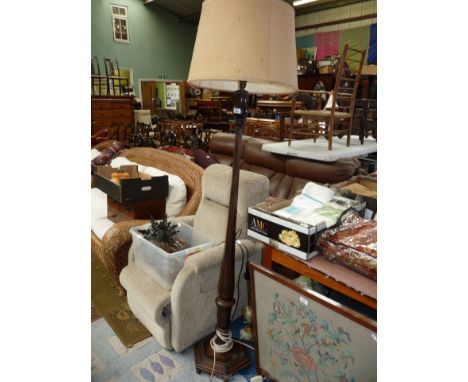 A wooden hexagonal based and column Standard Lamp with beige shade