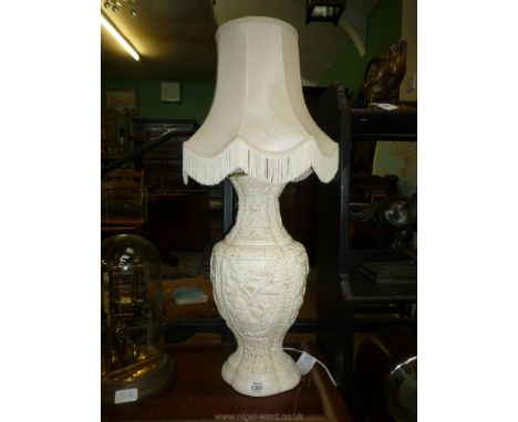 An embossed cream oriental style Table Lamp and shade