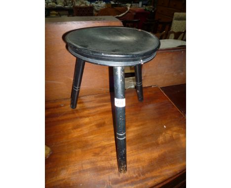A circular seated three legged ebonised Stool, 14'' high x 10'' diameter