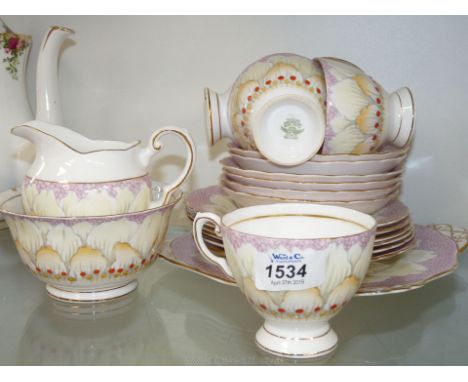 A pretty part teaset Tuscan in violet and yellow floral pattern comprising bread and butter plate, five cups, six tea plates,