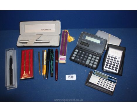 A quantity of old pens and pencils including Conway Stuart set and five vintage calculators, some scientific.