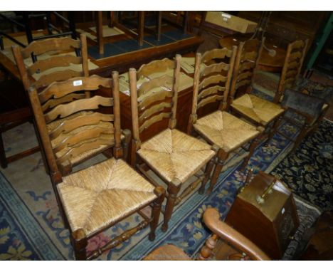 A good reproduction set of six Satinwood framed ladder back Dining Chairs having woven seagrass seats, turned front legs and 