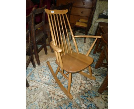 A stylish Ercol stick back Rocking Chair with turned legs and stretchers.