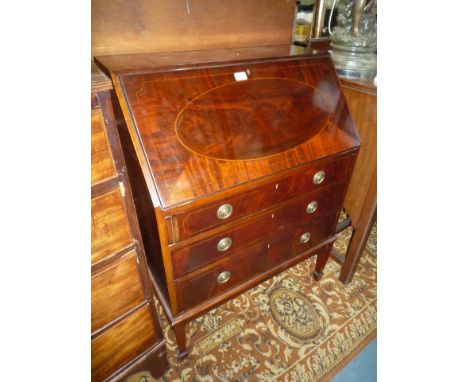An early 20th c. Mahogany Bureau with light and dark wood strung slope with oval panel &amp; quarter veneers revealing an int