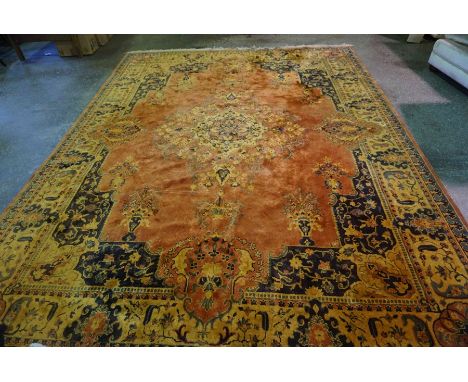 Indian Carpet, Decorated with allover floral medallions on a rust ground, 365cm x 276cm