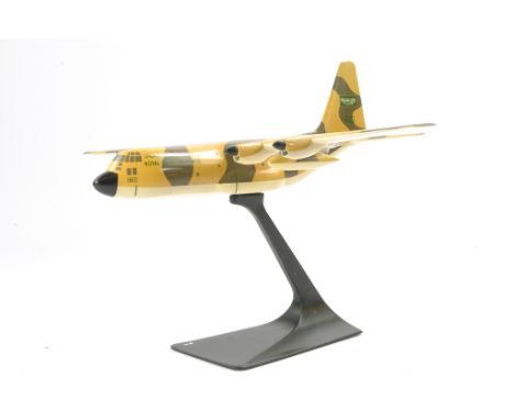 An unusual metal model aircraft (on stand) of the Lockheed Hercules in the livery of Royal Saudi Airforce. Some signs of wear