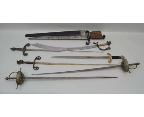 A COLLECTION OF SEVEN THEATRICAL SWORDS to include; a pair of basket hilted rapiers, various decorative handles, and a broad 