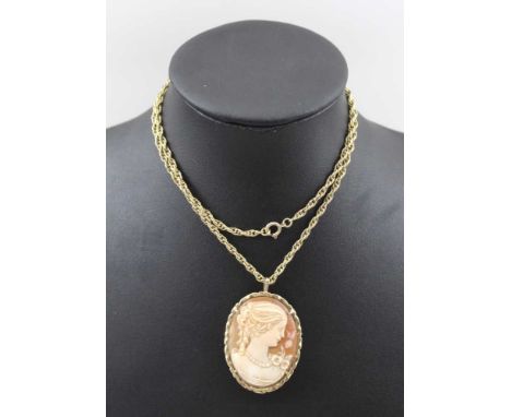 A 9CT GOLD FRAMED CAMEO, portrait of a lady, with both pin and pendant fitting, 4cm x 3cm, on a 9ct gold chain, weight of cha