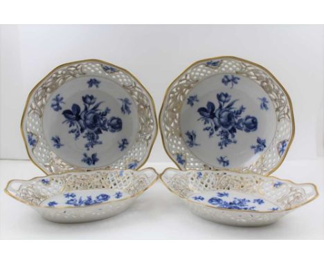 A PAIR OF SCHUMANN PORCELAIN BOWLS, with reticulated gilded rims, blue rose decoration to the soles, 23cm diameter, together 