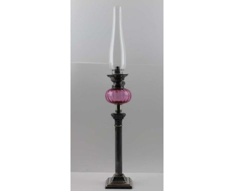 A FRENCH OIL LAMP BY "GAUDARD" having cranberry glass reservoir over a silver plated Corinthian column, approx 65cm high over