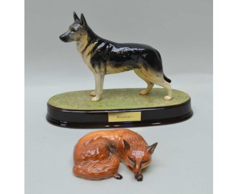A BESWICK FIGURE OF AN ALSATIAN, on an oval ceramic base with name plate, together with A BESWICK FOX lying down, No.1017 (2)