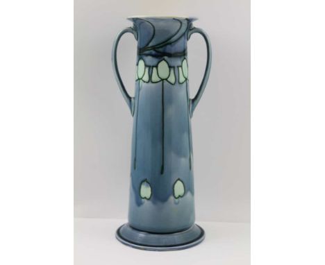 A MINTON SECESSIONIST CERAMIC VASE of tapering cylindrical form, with two handles, flared rim on circular platform foot, styl