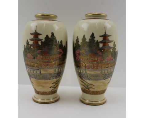 A PAIR OF JAPANESE MEIJI PERIOD SATSUMA CERAMIC VASES of baluster form, painted and gilded in colours on a cream ground, land