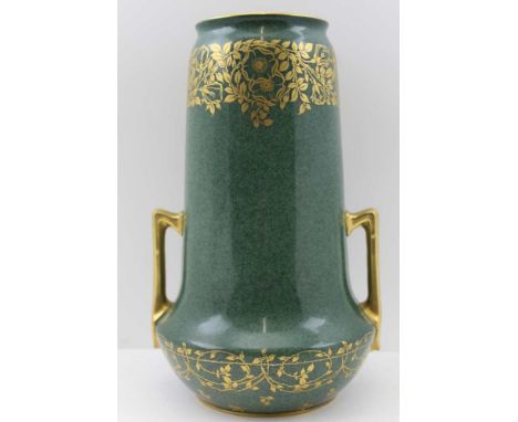 A ROYAL WORCESTER VASE of cylindrical form, fitted a pair of gilded handles, mottled green celadon ground, with gilded floral