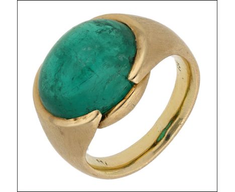 A Colombian emerald ring, the oval emerald cabochon in a satin finished tapered mount, stamped ‘750’, emerald measurements 13